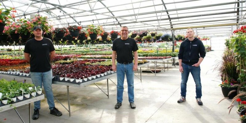 All three Lacoste team members standing in the greenhouse